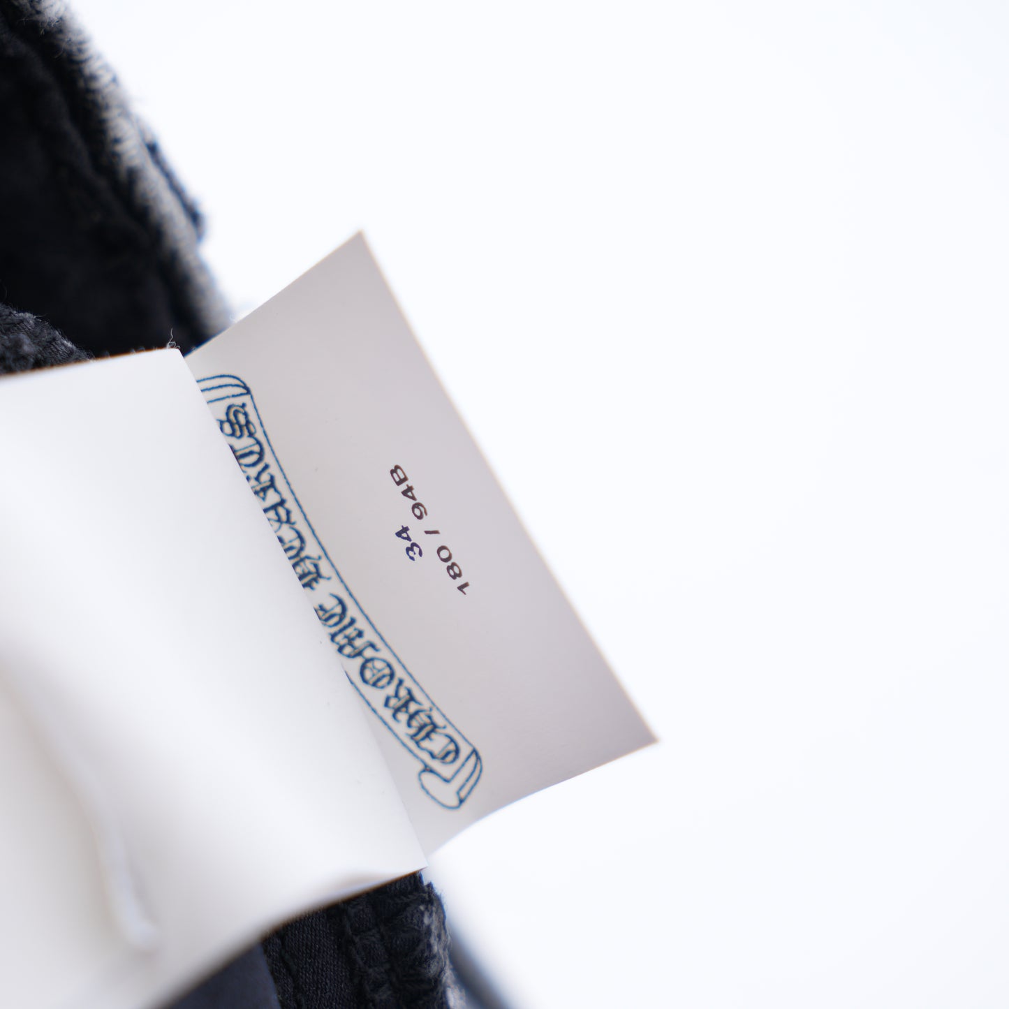 CHROME HEARTS BLACK AND WHITE PATCH FLEUR KNEE DENIM